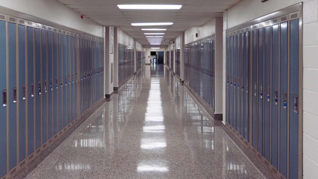 Empty school hallway representing warning signs and isolation associated with Ritalin addiction in teens